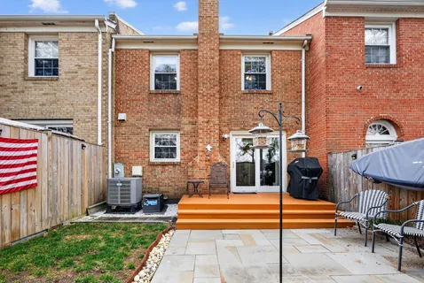 a front view of a house with a garden and patio