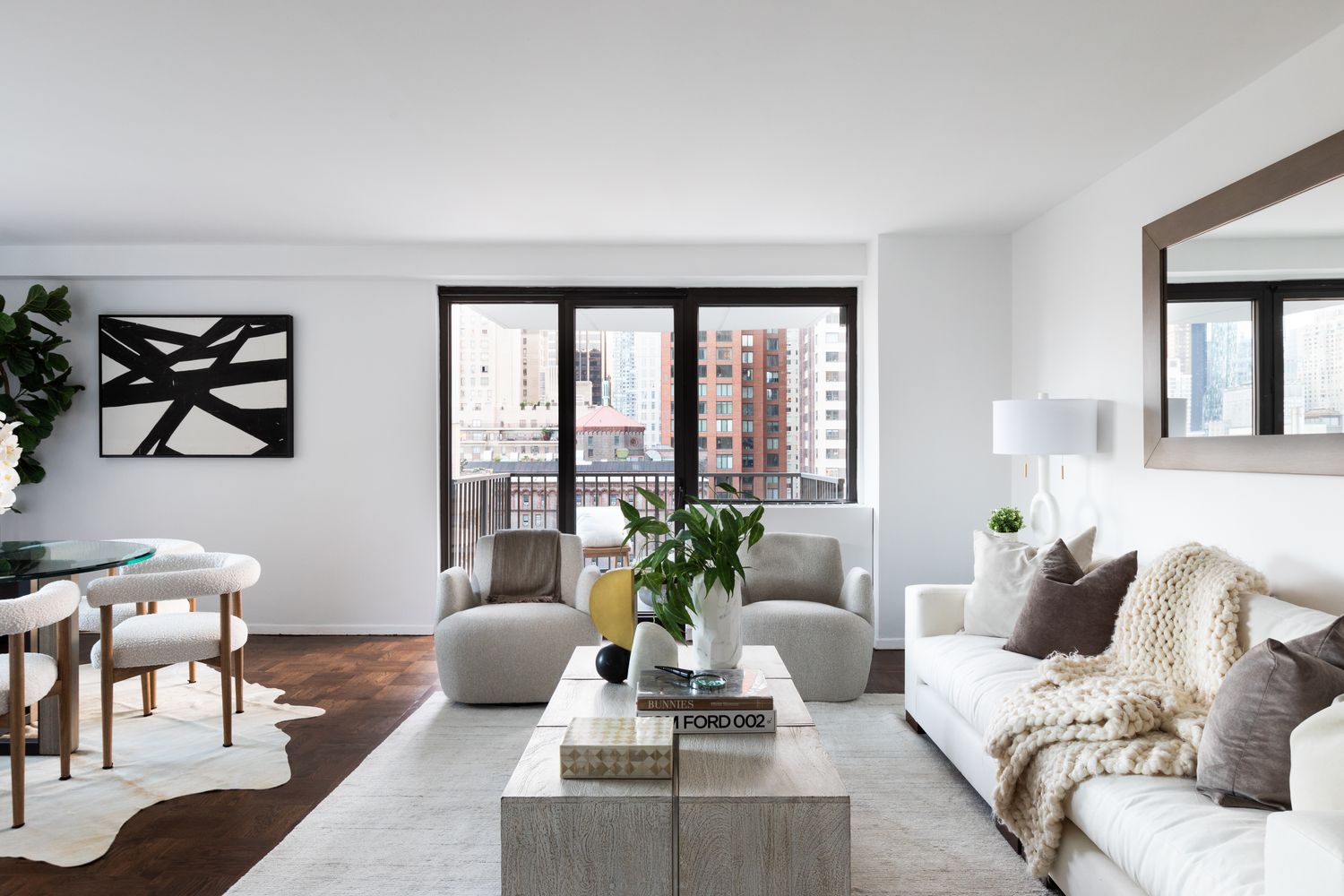 a living room with furniture and floor to ceiling windows