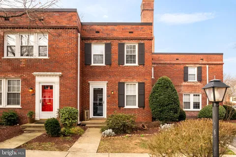 front view of a brick house with a yard