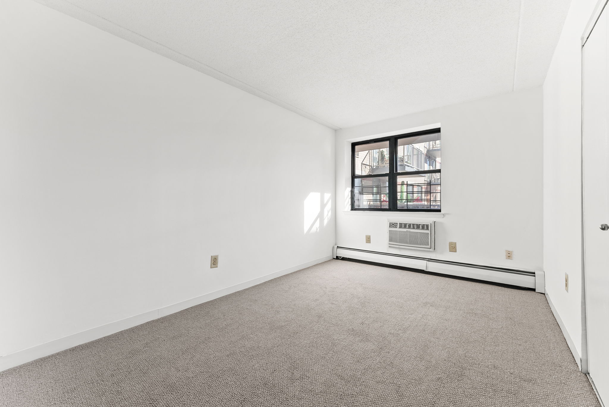 1919 Madison Avenue, Unit 214 Manhattan, NY 10035 - Photo 14 of 19 an empty room with windows