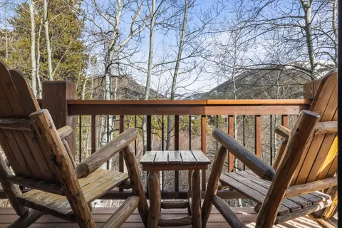 a view of a balcony with wooden chairs and floor