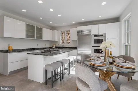 a kitchen with granite countertop a sink stove and refrigerator