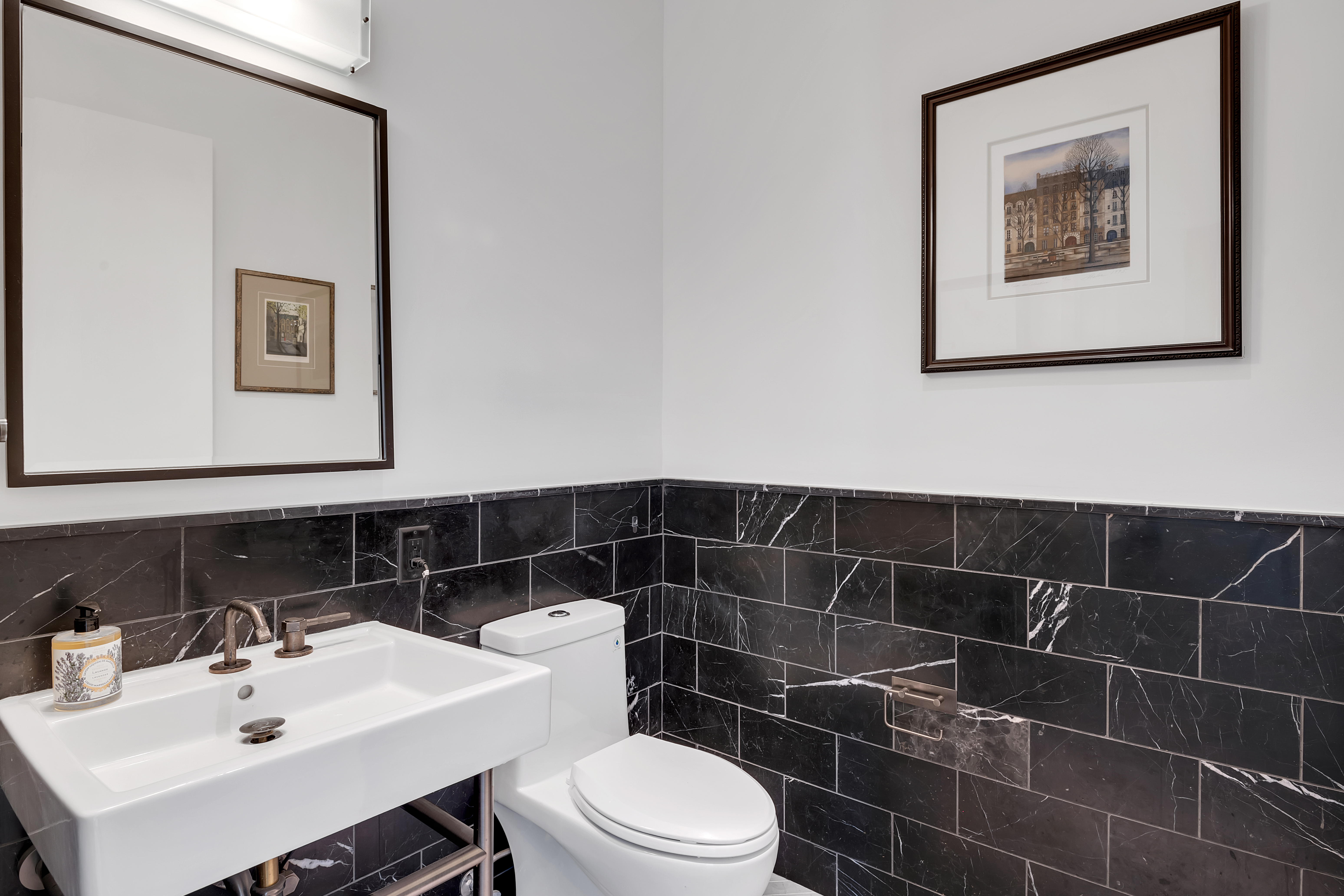 959 1st Avenue, Unit 25H Manhattan, NY 10022 - Photo 12 of 18 a bathroom with a toilet a sink and mirror