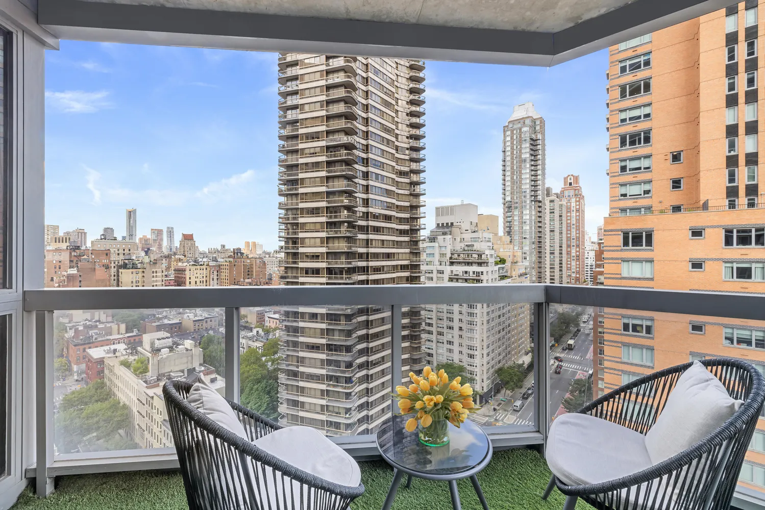 a view of a balcony with two chairs and a table