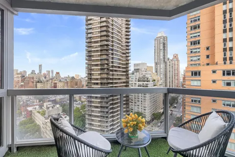 a view of a balcony with two chairs and a table