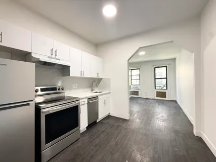 a kitchen with granite countertop a stove and a sink
