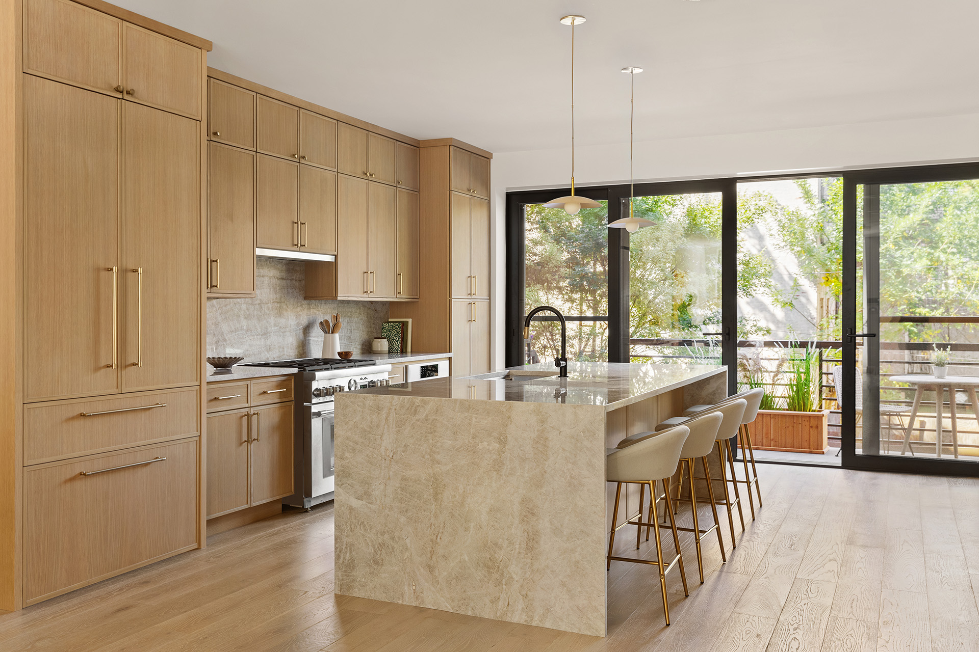 532 Clinton Street Brooklyn, NY 11231 - Photo 3 of 15 a kitchen with stainless steel appliances granite countertop a stove a refrigerator a kitchen island a stove and a cabinets with wooden floor
