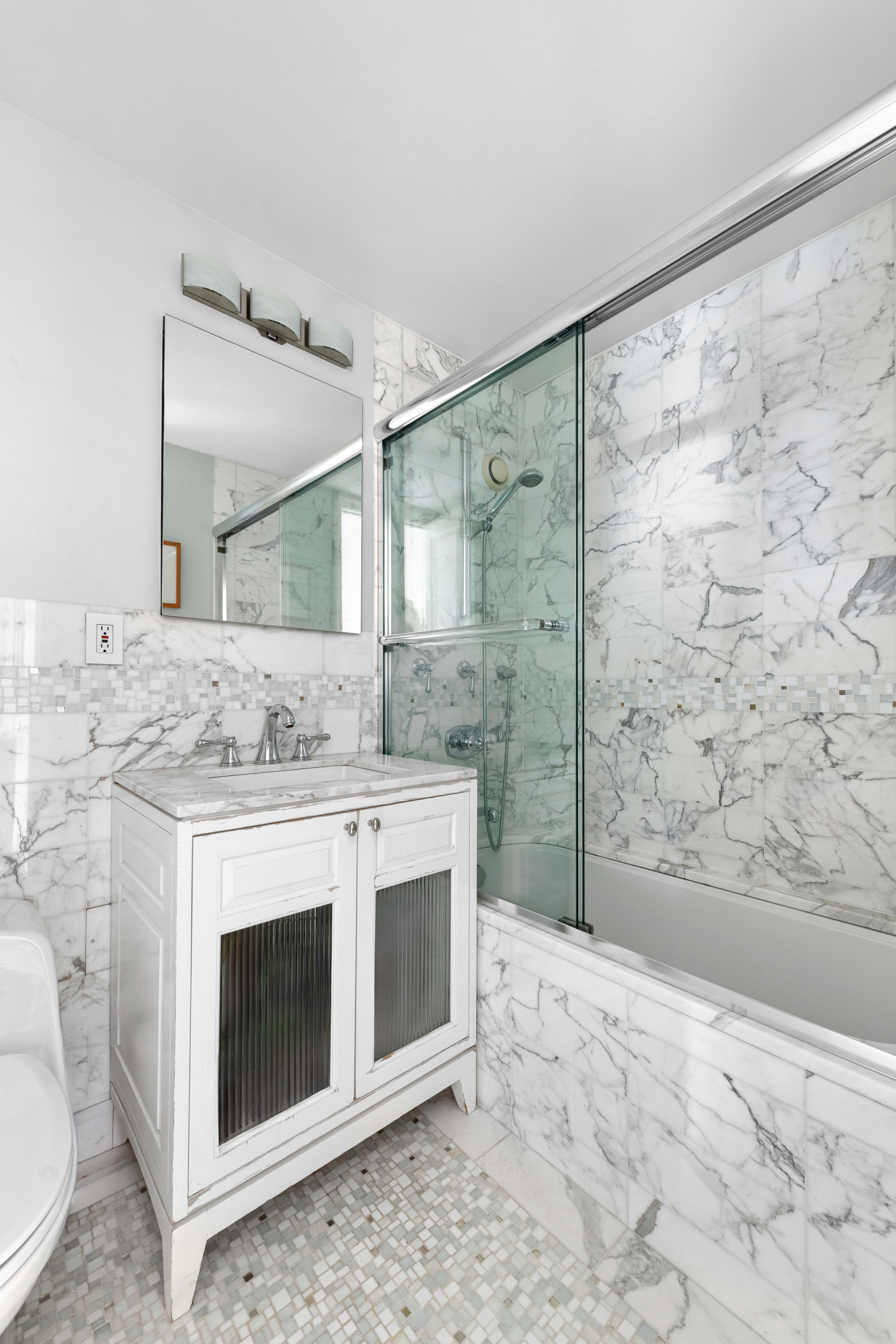 444 East 86th Street, Unit 25EF Manhattan, NY 10028 - Photo 7 of 18 a bathroom with a sink and a mirror