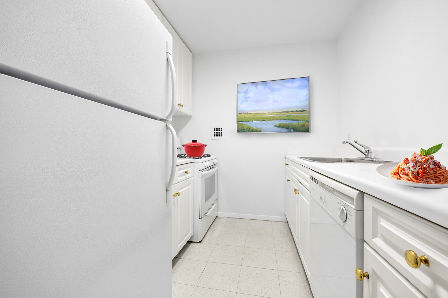 595 Main Street, Unit 315 Manhattan, NY 10044 - Photo 9 of 11 a utility room with cabinets washer and dryer