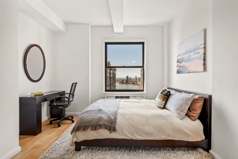 a bedroom with a bed a desk and chair