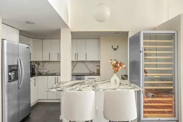 a kitchen with refrigerator and cabinets