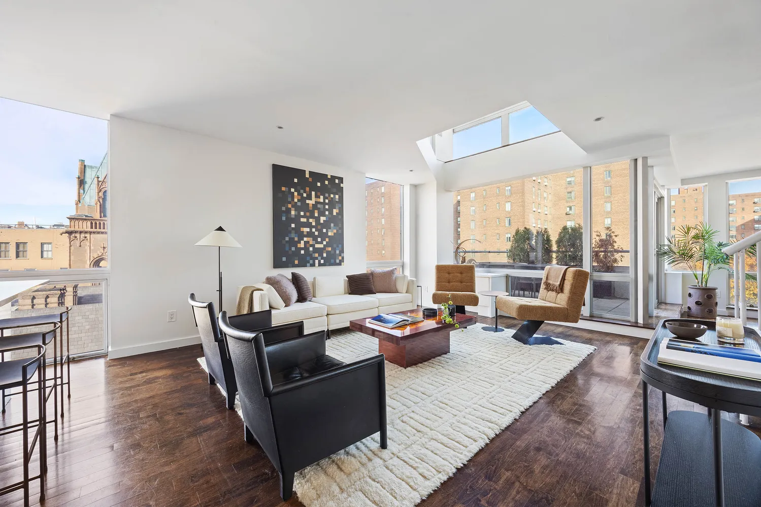 a living room with furniture and large windows