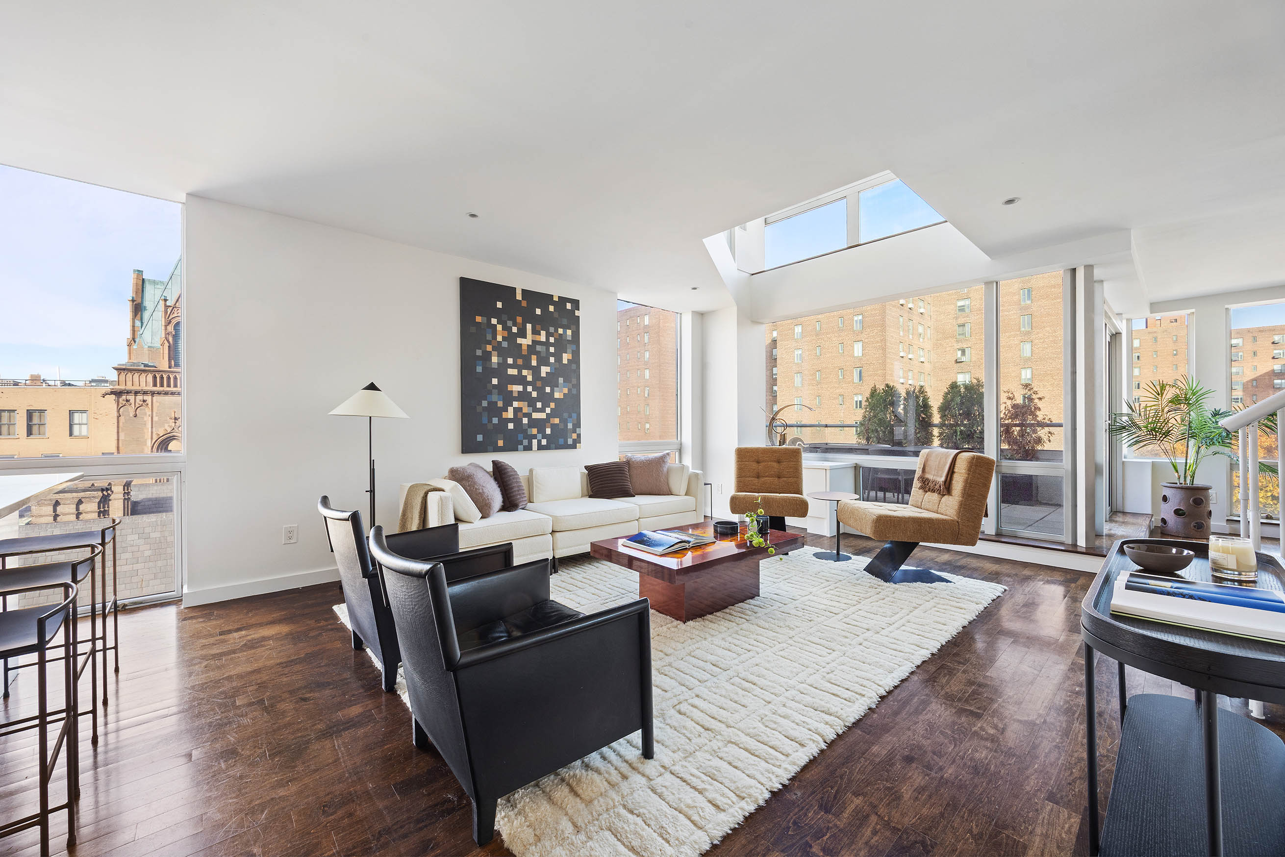 a living room with furniture and large windows