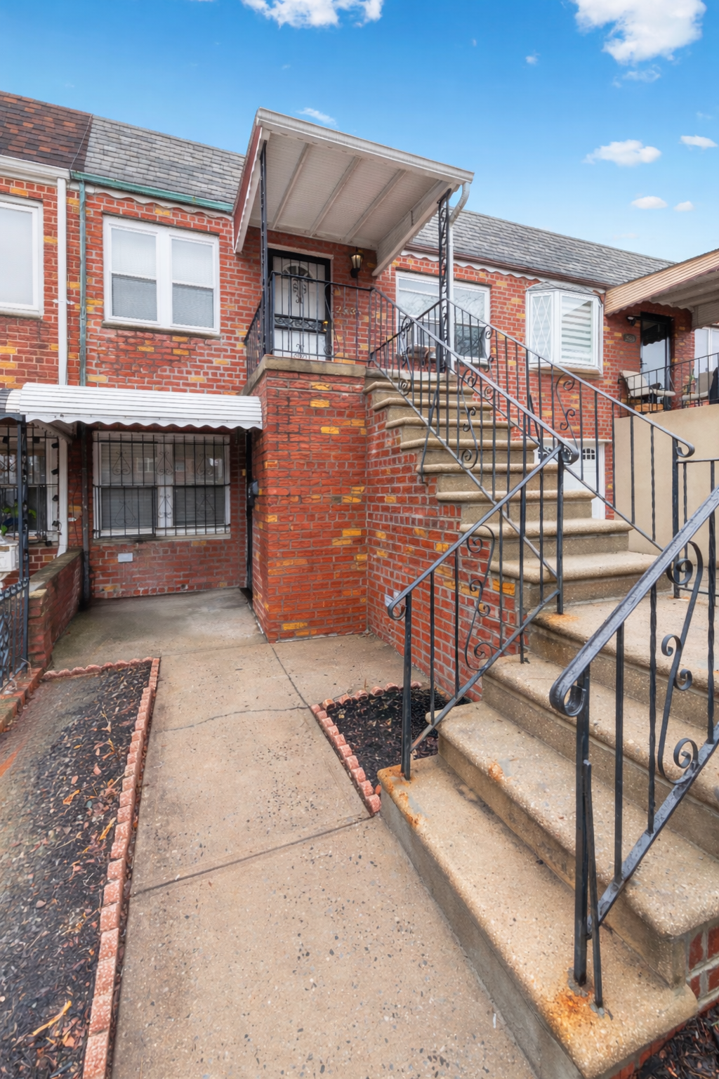 25-36 72nd Street Queens, NY 11370 - Photo 16 of 17 front view of a house with a street
