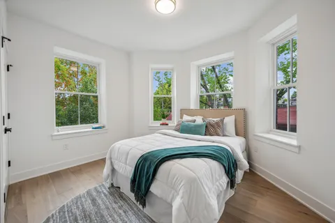a bedroom with a bed and a window