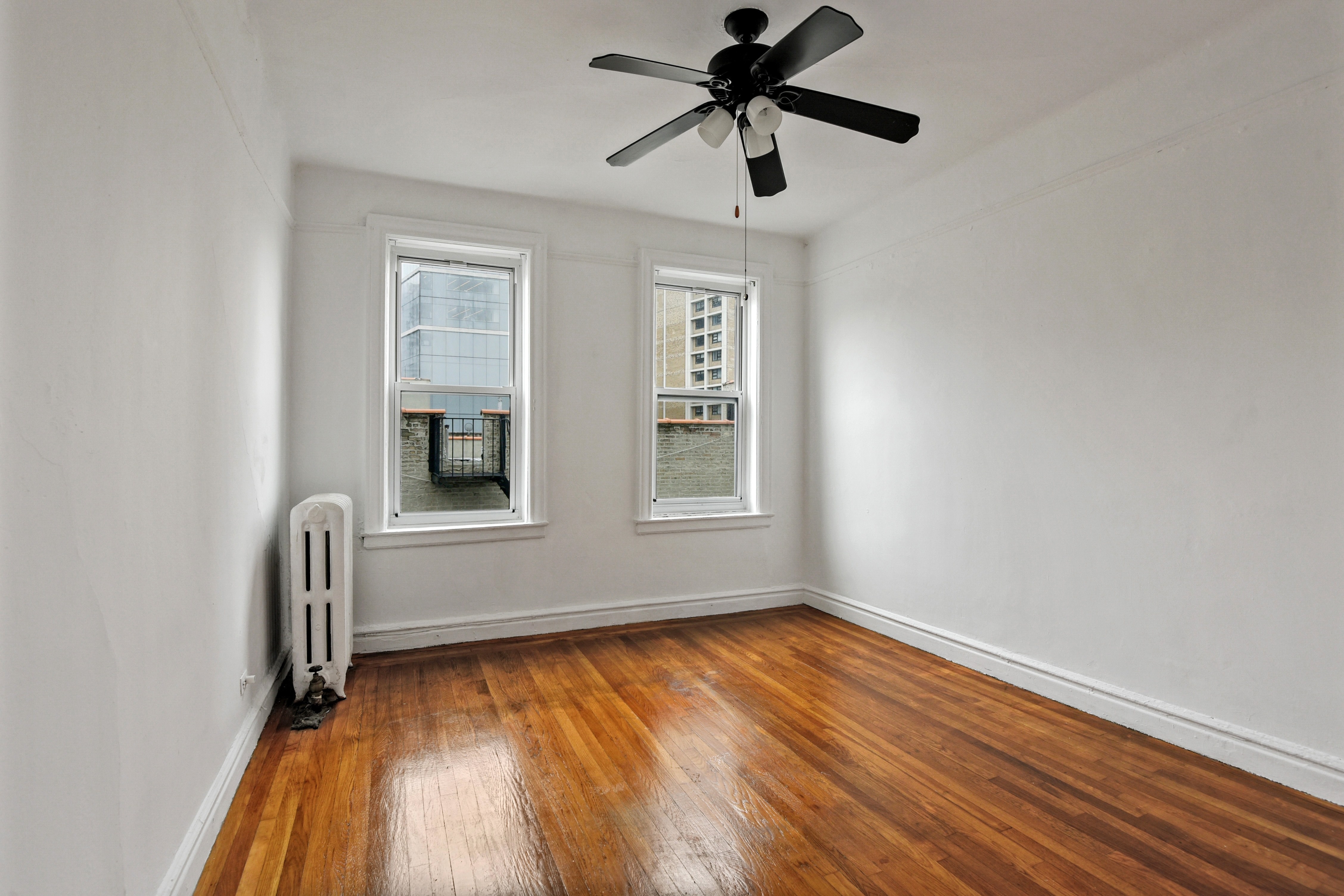 720 West 173rd Street, Unit 59 Manhattan, NY 10032 - Photo 7 of 11 an empty room with a window and a ceiling fan