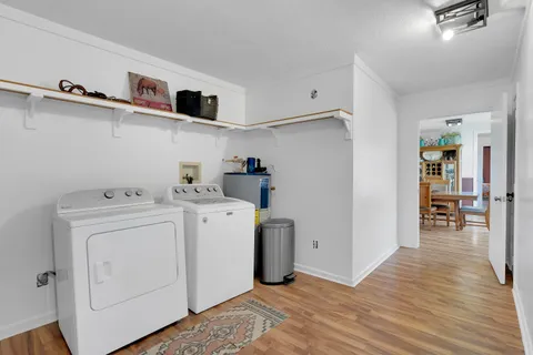 a view of storage and utility room with wooden floor