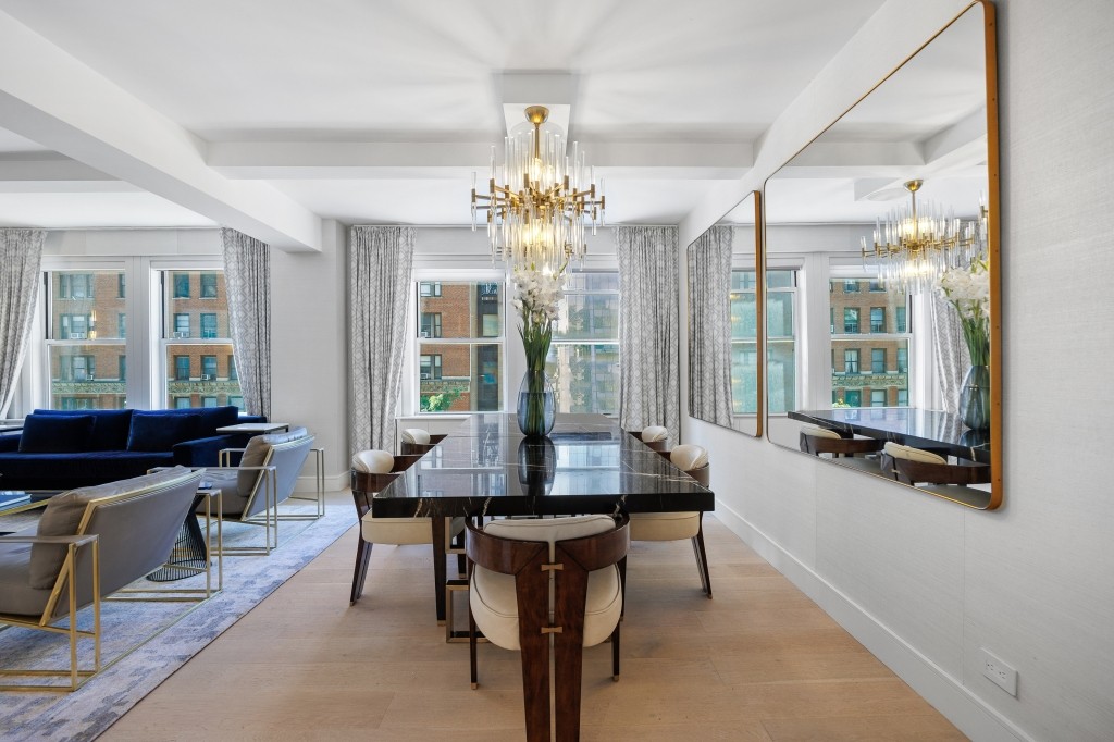 433 West 34th Street, Unit 4ABC Manhattan, NY 10001 - Photo 8 of 20 a dining room with wooden floor a chandelier a wooden table and chairs