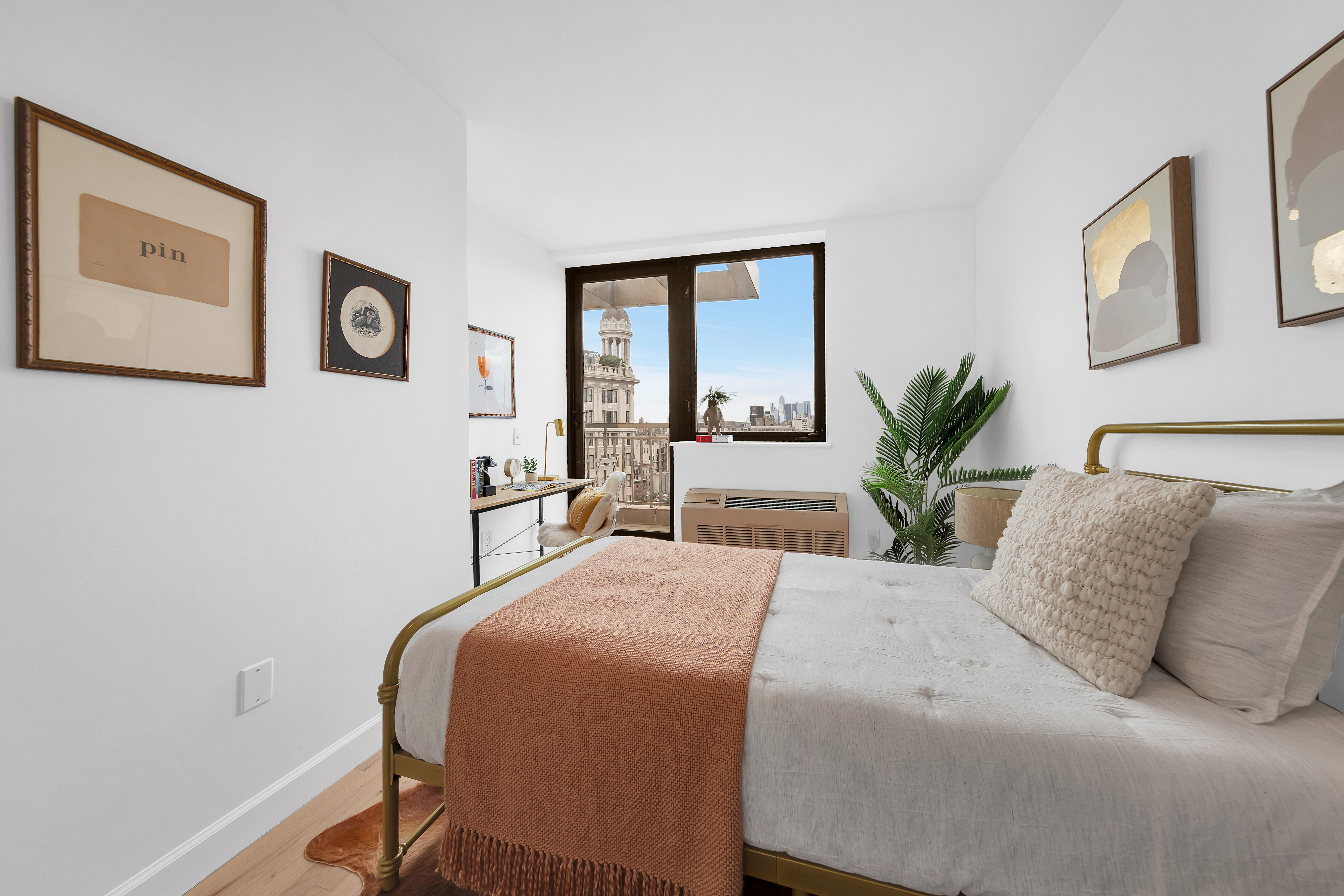 136 East Broadway, Unit PHA Manhattan, NY 10002 - Photo 8 of 12 a spacious bedroom with a large bed and a potted plant