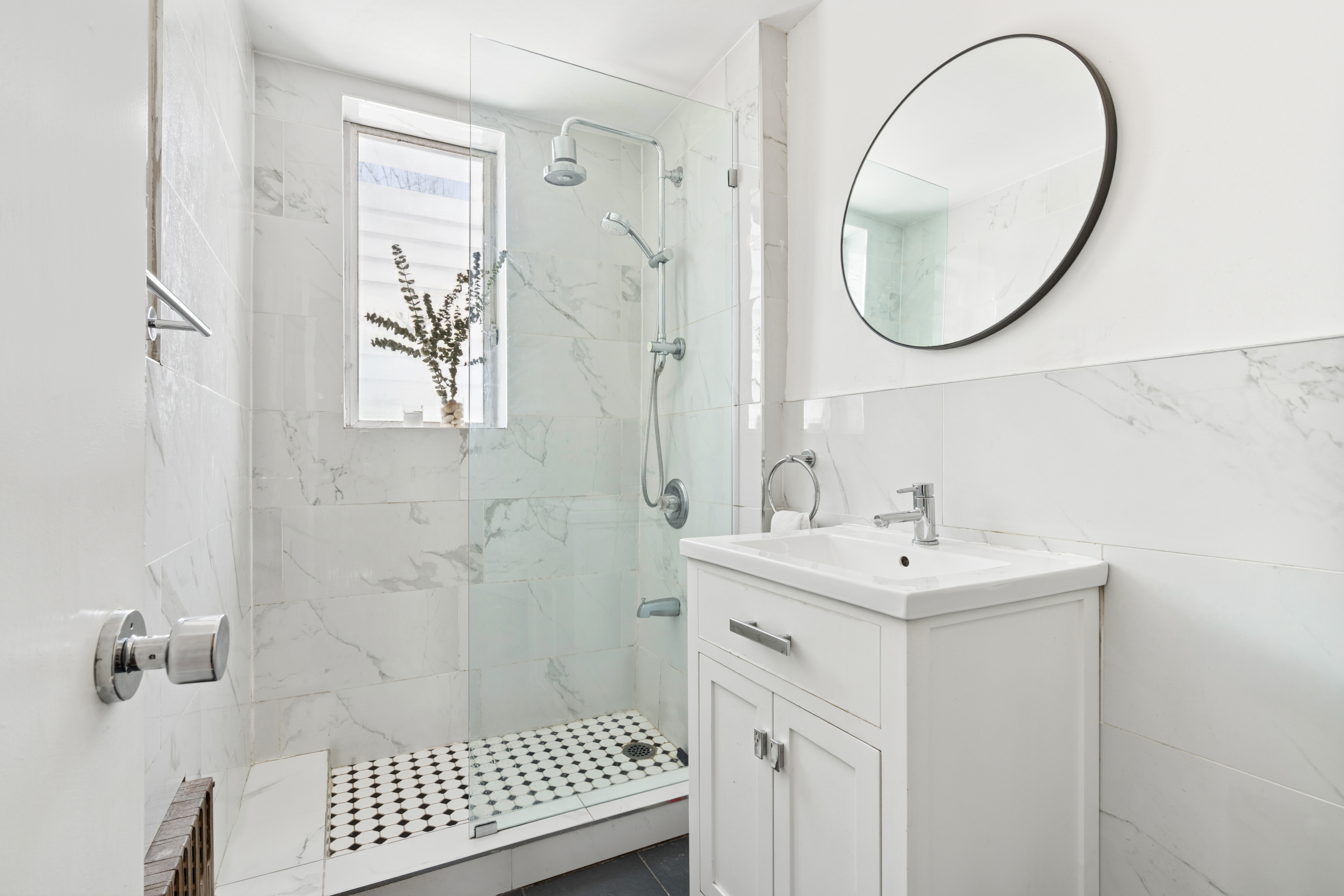 527 East 38th Street Brooklyn, NY 11203 - Photo 9 of 15 a bathroom with a sink a mirror a vanity and a shower