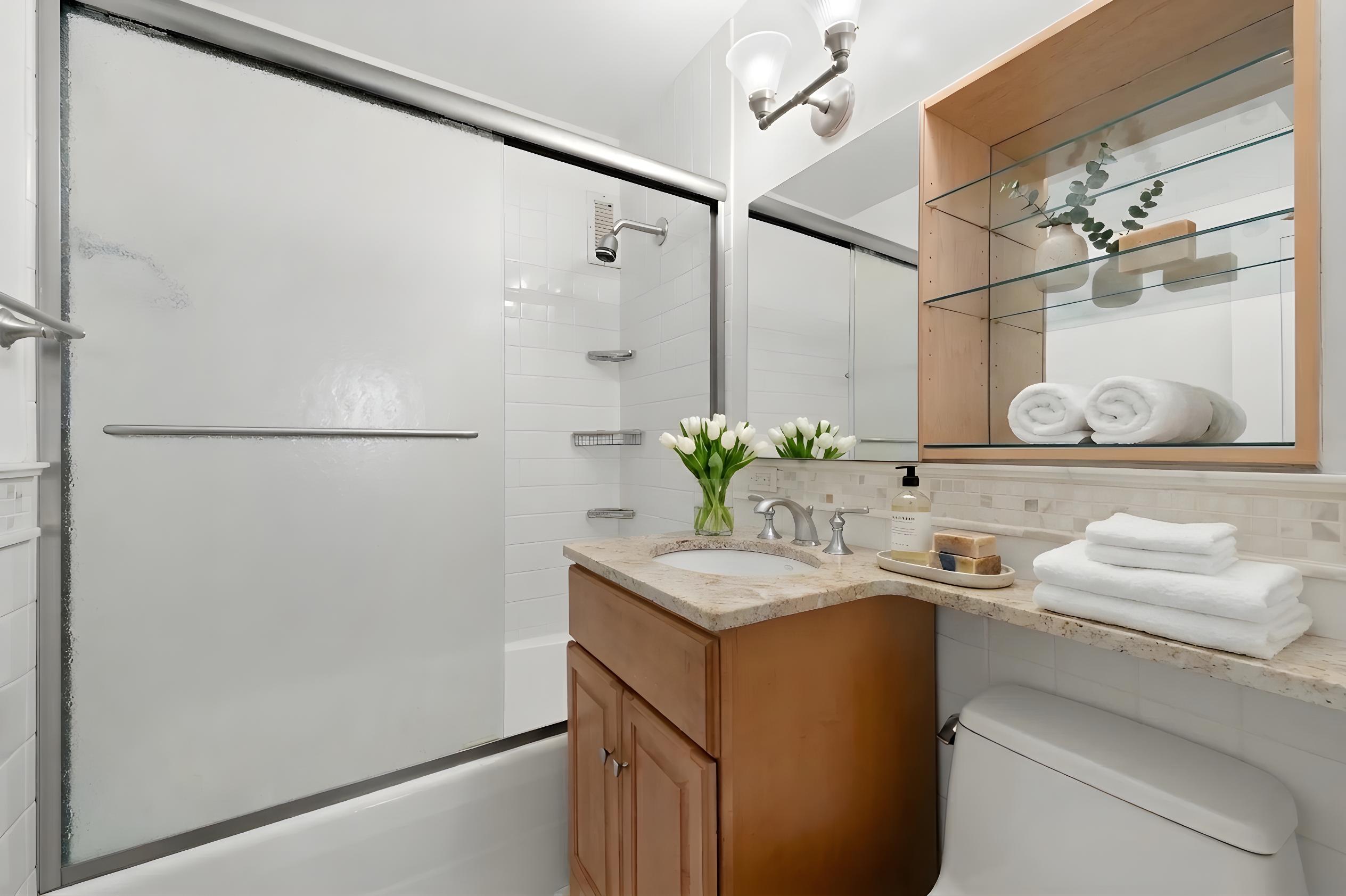 10 West 66th Street, Unit 7C Manhattan, NY 10023 - Photo 8 of 19 a bathroom with a sink and a mirror
