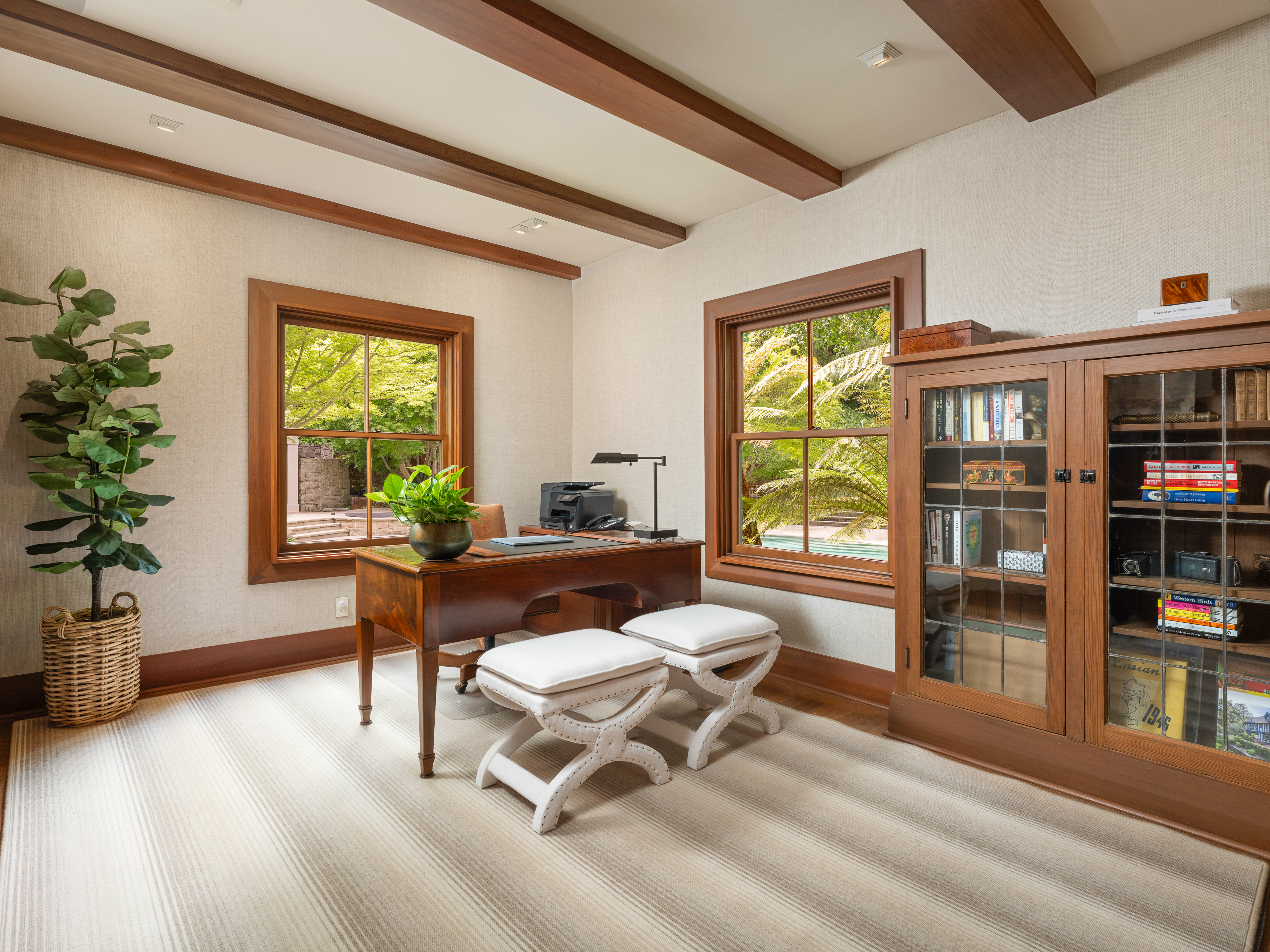 37 Upper Road Ross, CA 94957 - Photo 19 of 68 a living room with furniture a bookshelf and a potted plant