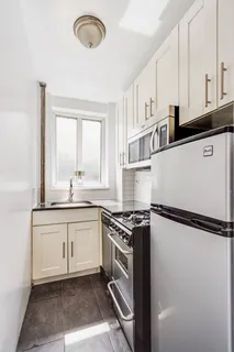a kitchen with granite countertop a sink stainless steel appliances and cabinets