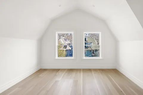 a view of a room with wooden floor and staircase
