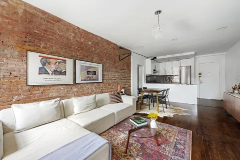 a living room with furniture and kitchen view