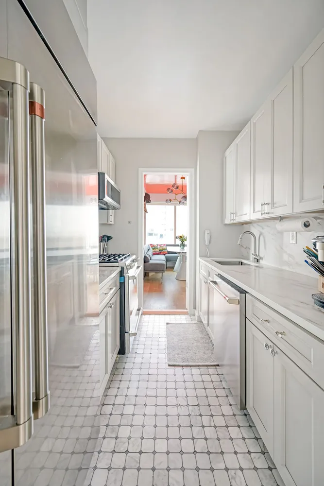 a kitchen with stainless steel appliances a refrigerator sink and cabinets