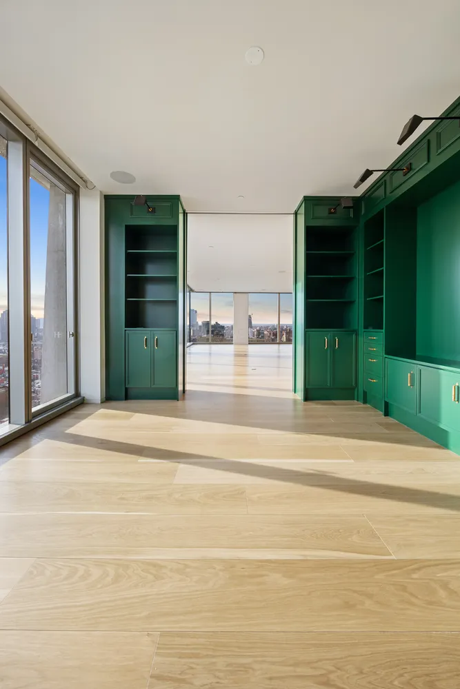 a living room with a furniture and a large window