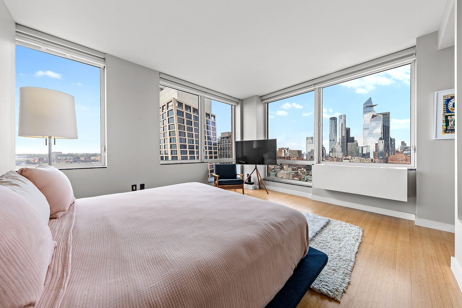 450 West 17th Street, Unit 2208 Manhattan, NY 10011 - Photo 5 of 8 a bedroom with a bed and a large window