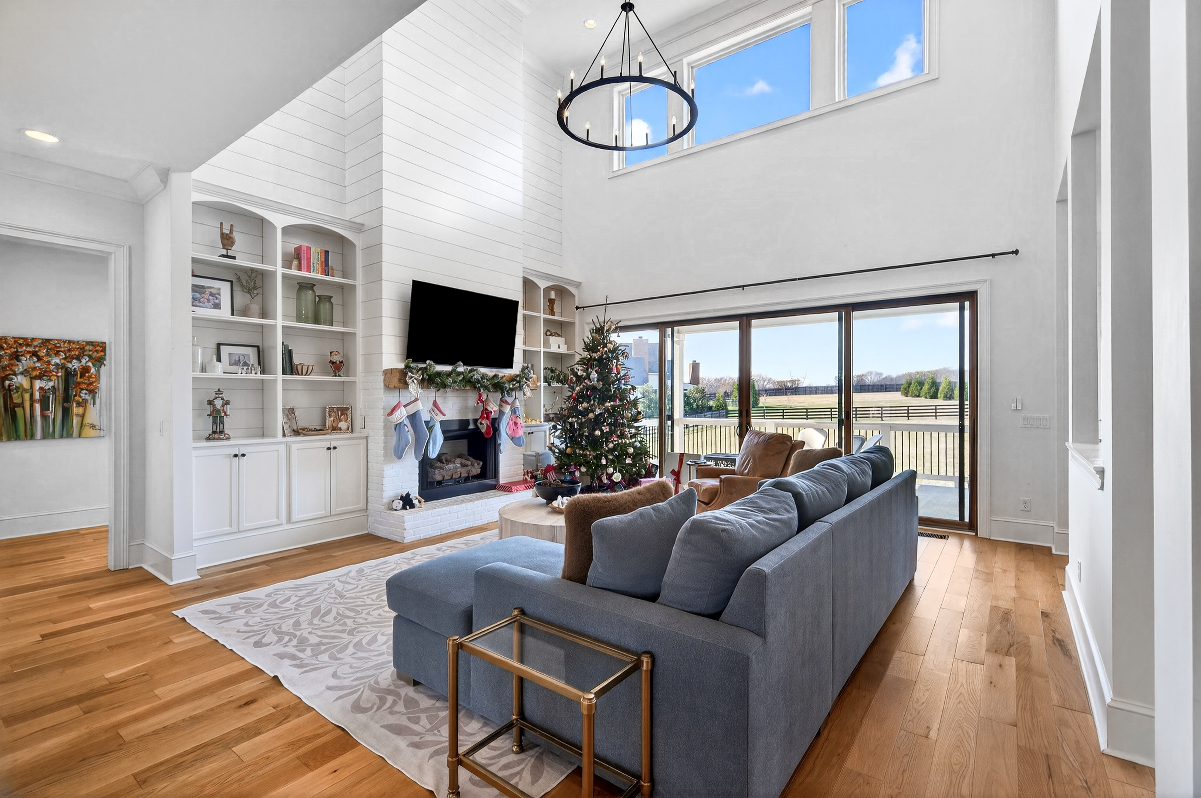 1703 Swansons Rdg Drive Franklin, TN 37064 - Photo 15 of 67 a living room with furniture a flat screen tv and a floor to ceiling window