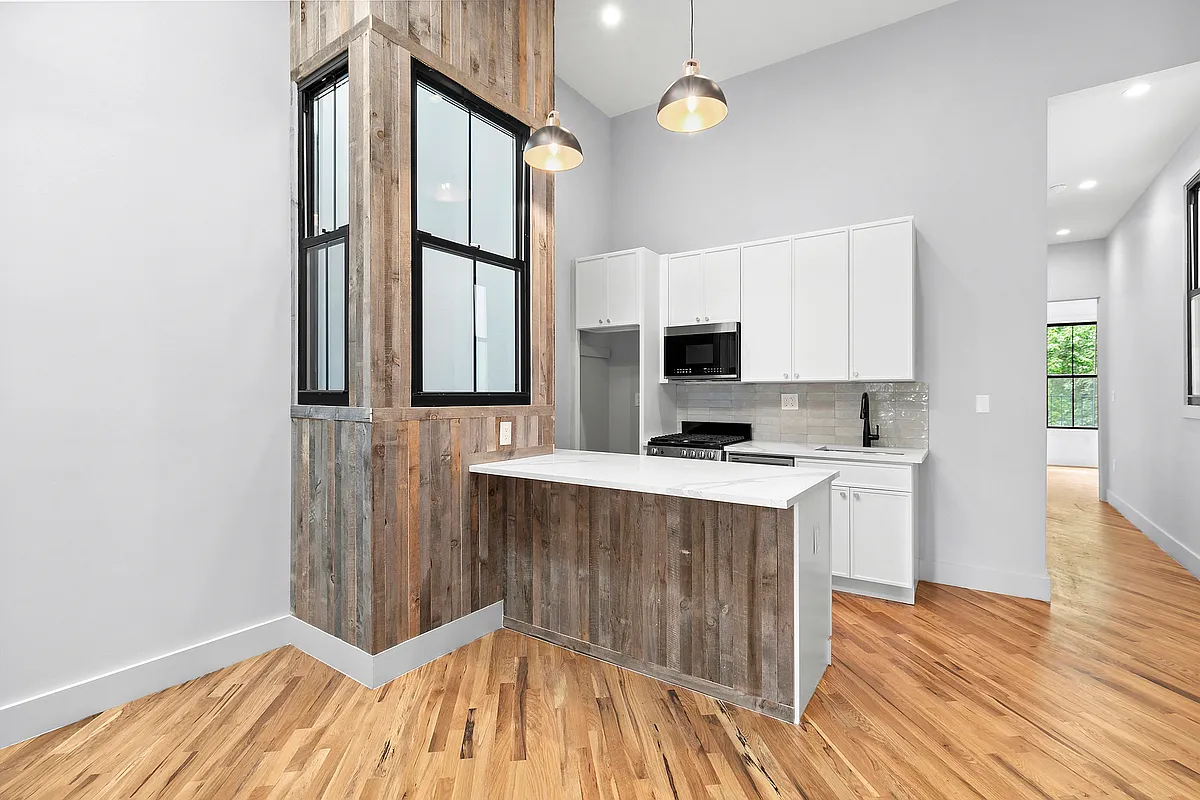 866 Bushwick Avenue, Unit 1 Brooklyn, NY 11221 - Photo 4 of 13 a view of kitchen with wooden floor and electronic appliances