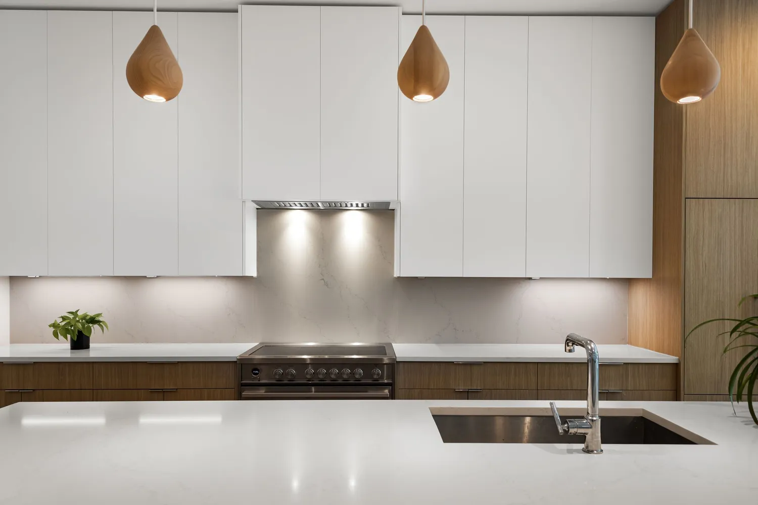a kitchen with a sink a stove and cabinets