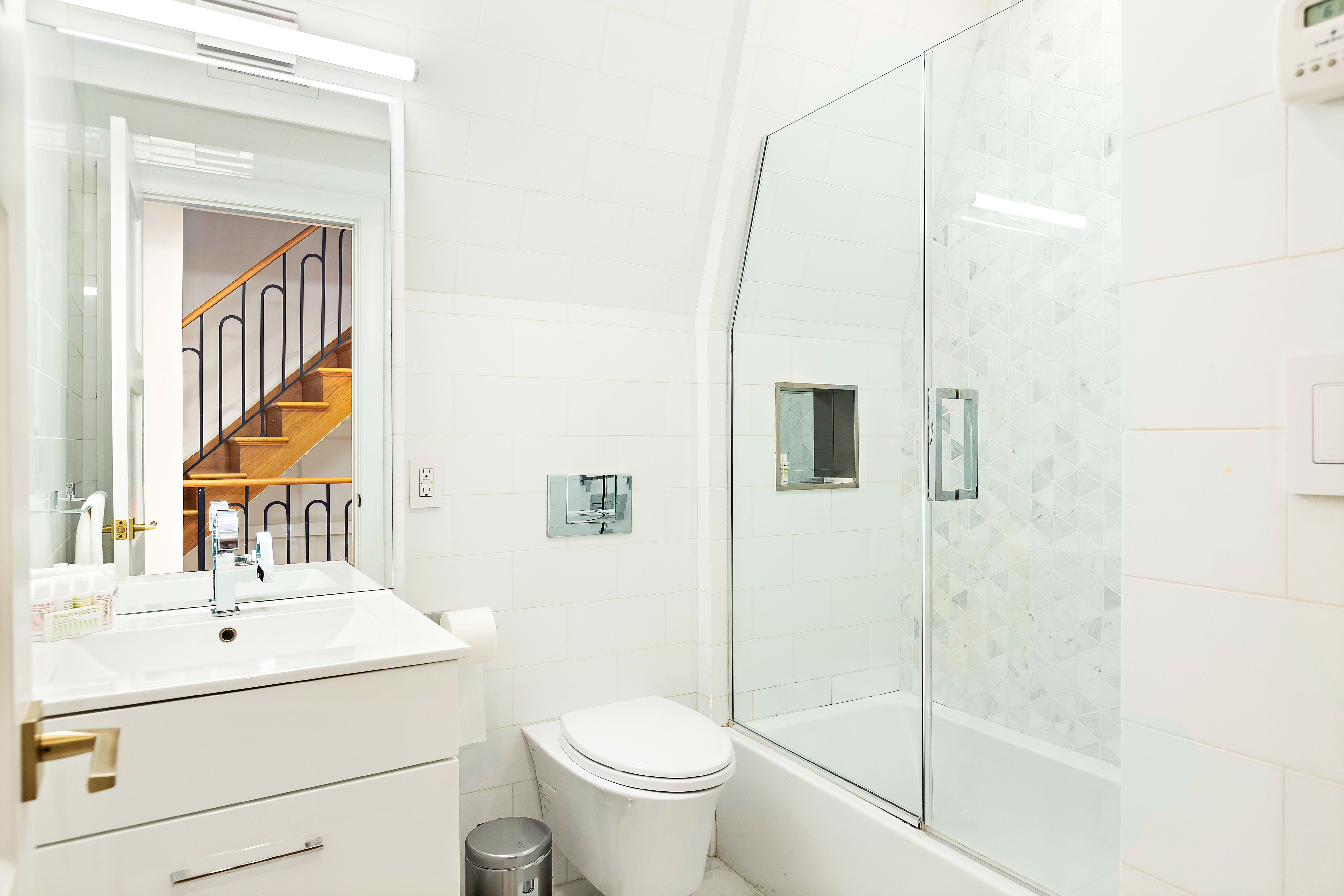 134 East 36th Street Manhattan, NY 10016 - Photo 26 of 28 a bathroom with a sink a toilet and shower