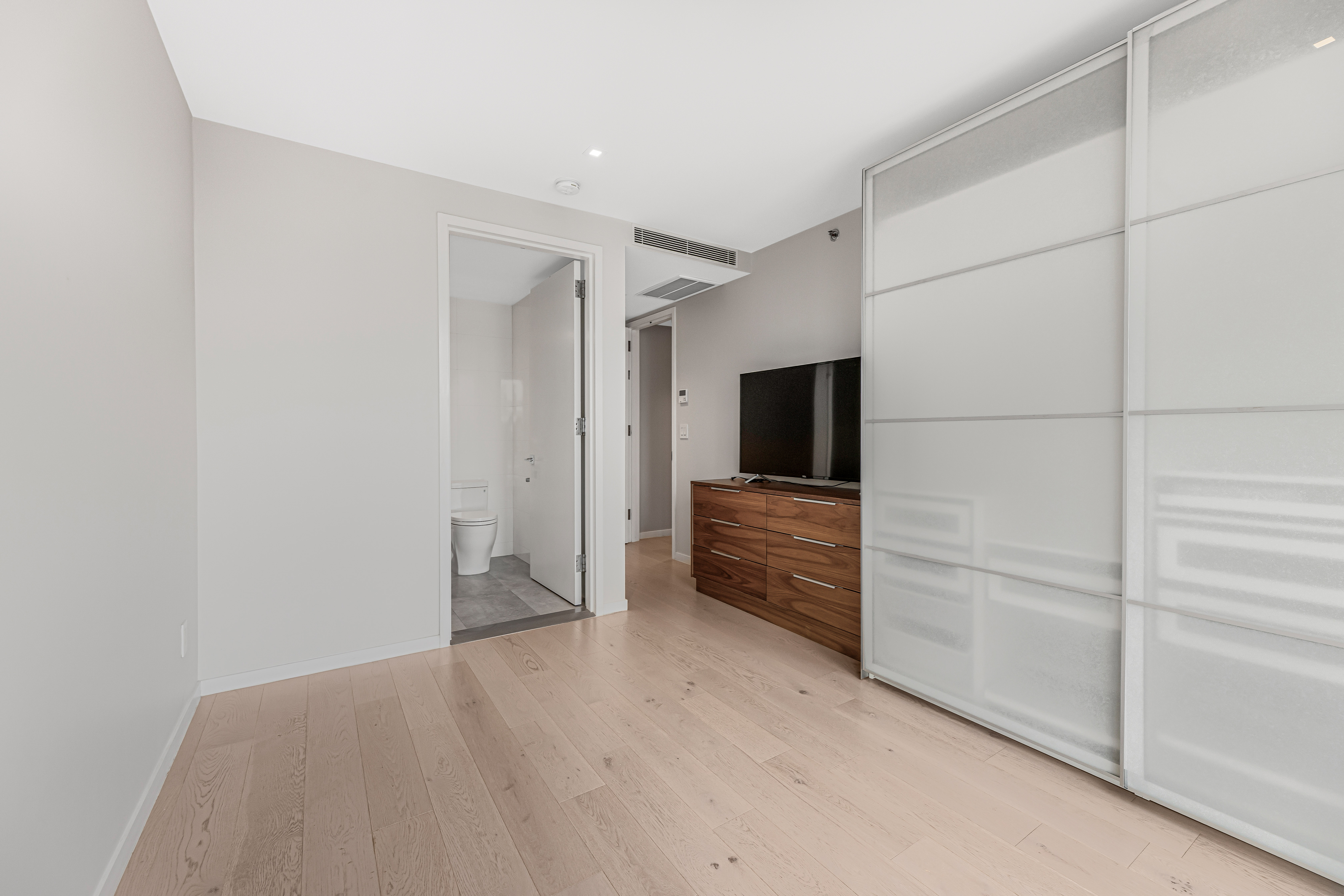 42-50 27th Street, Unit 9C Queens, NY 11101 - Photo 5 of 32 a view of walk in closet with empty racks
