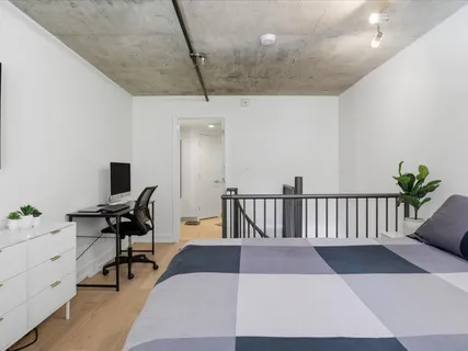 a bedroom with a bed and a desk