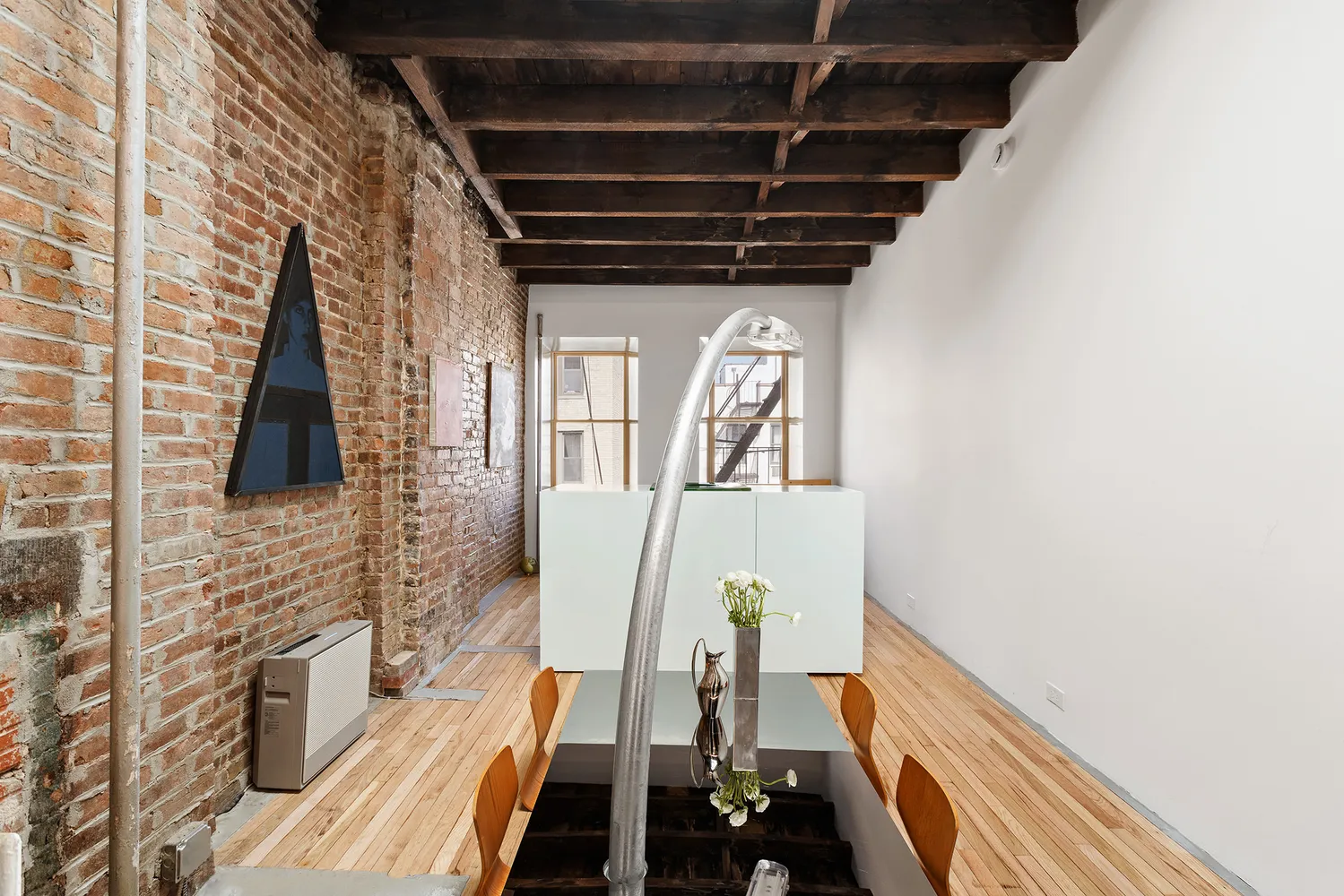 a view of an entryway with wooden floor