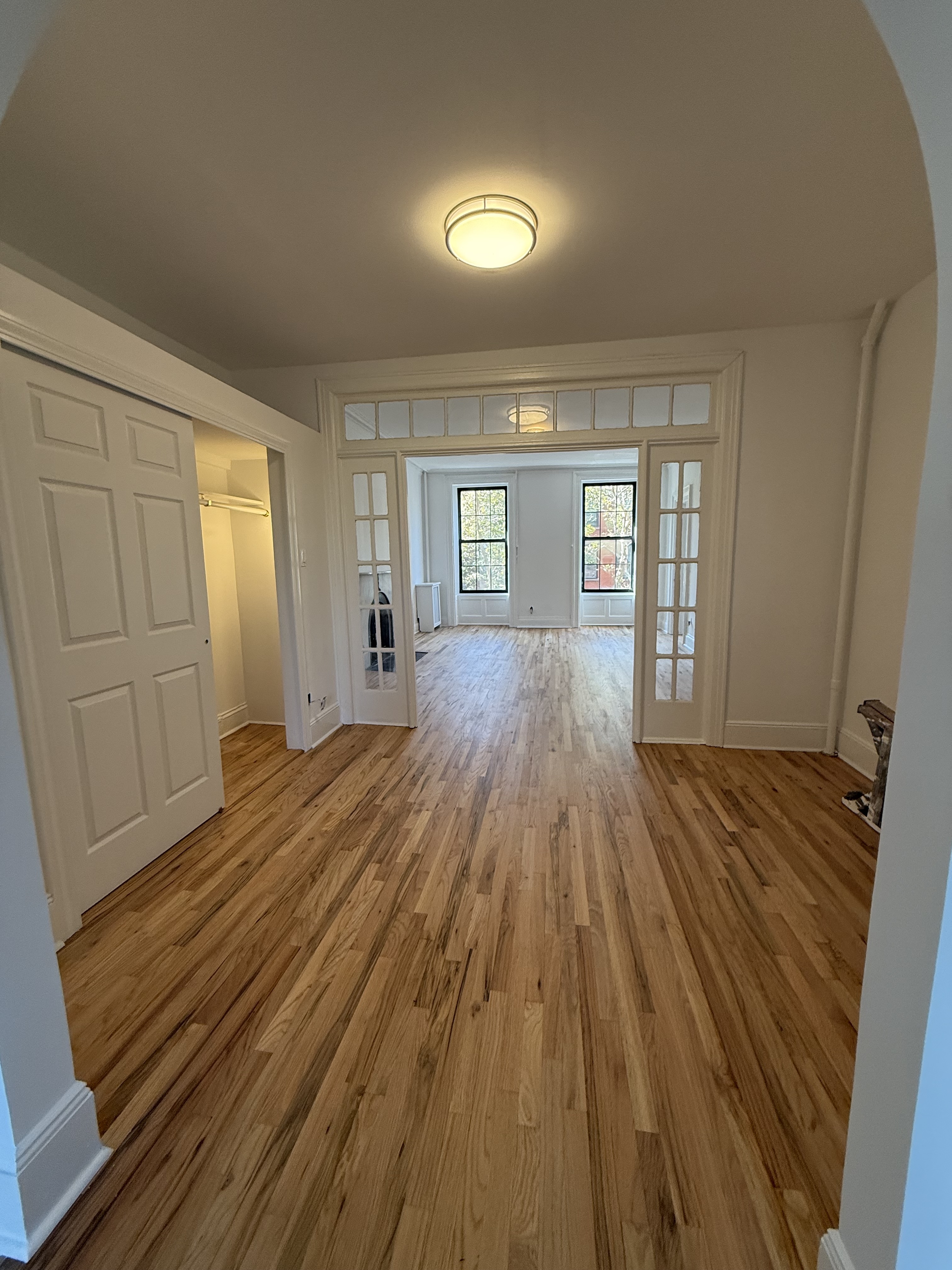 141 Summit Street, Unit 3 Brooklyn, NY 11231 - Photo 4 of 17 a view of a room with wooden floor and staircase