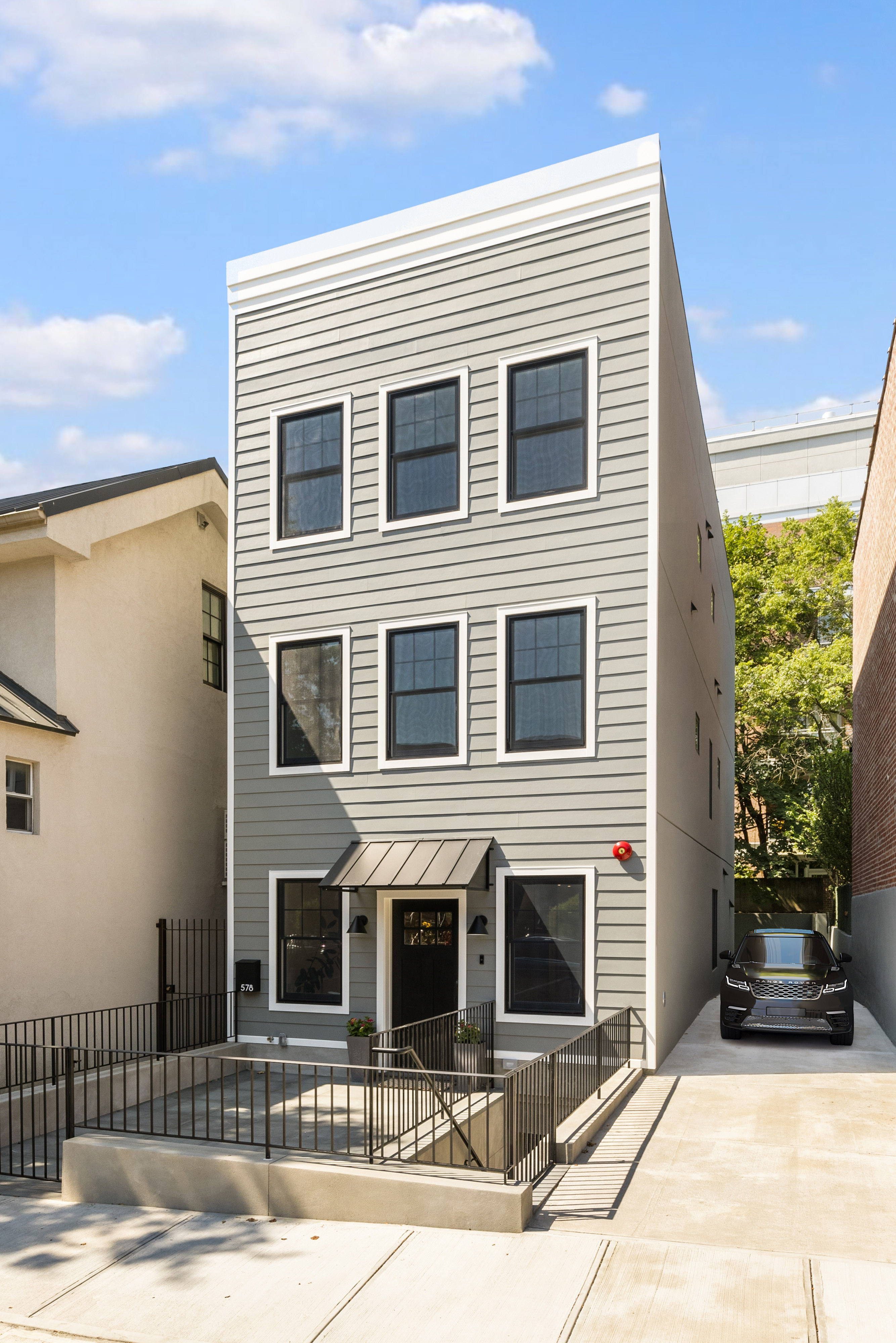 578 20th Street Brooklyn, NY 11218 - Photo 27 of 28 a front view of a house with a yard