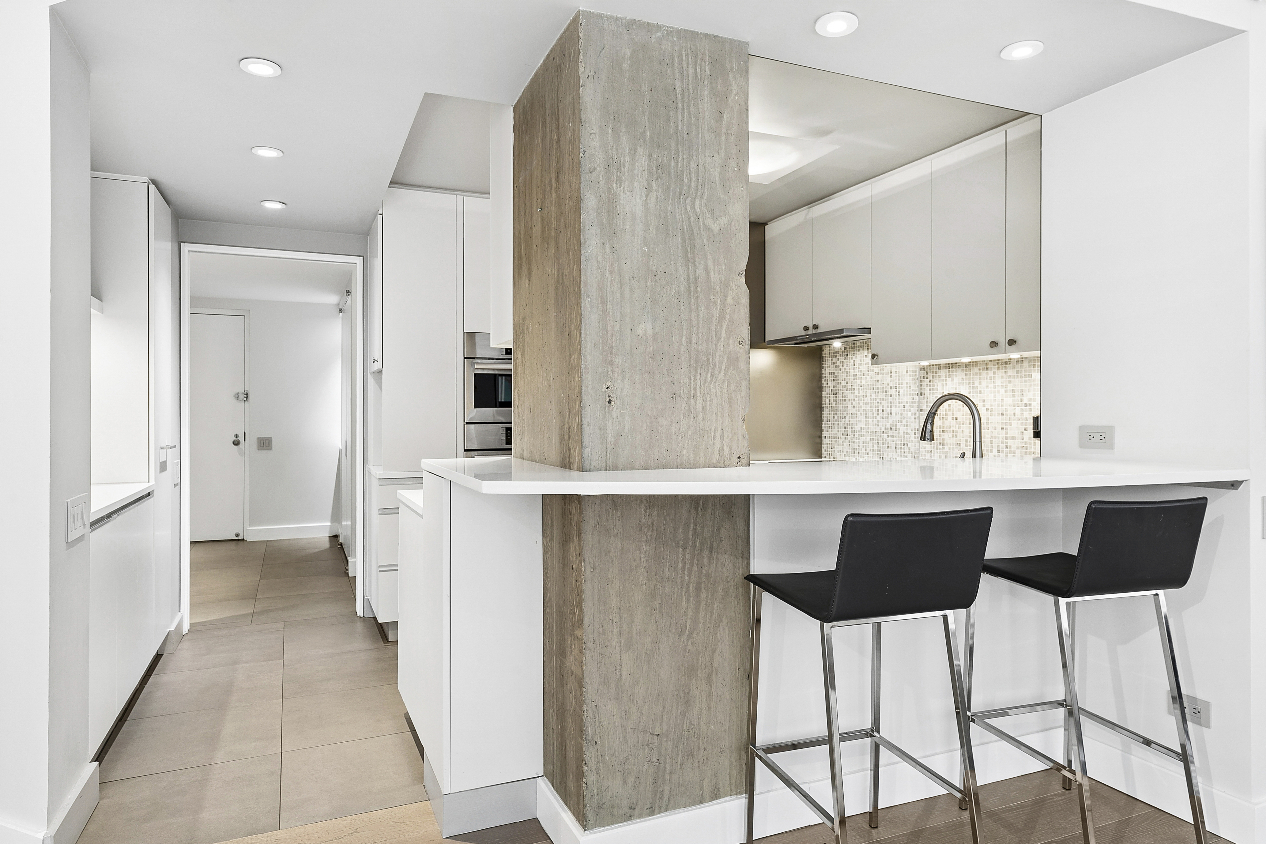 1065 Park Avenue, Unit 4BC Manhattan, NY 10128 - Photo 3 of 16 a kitchen with a sink and a refrigerator