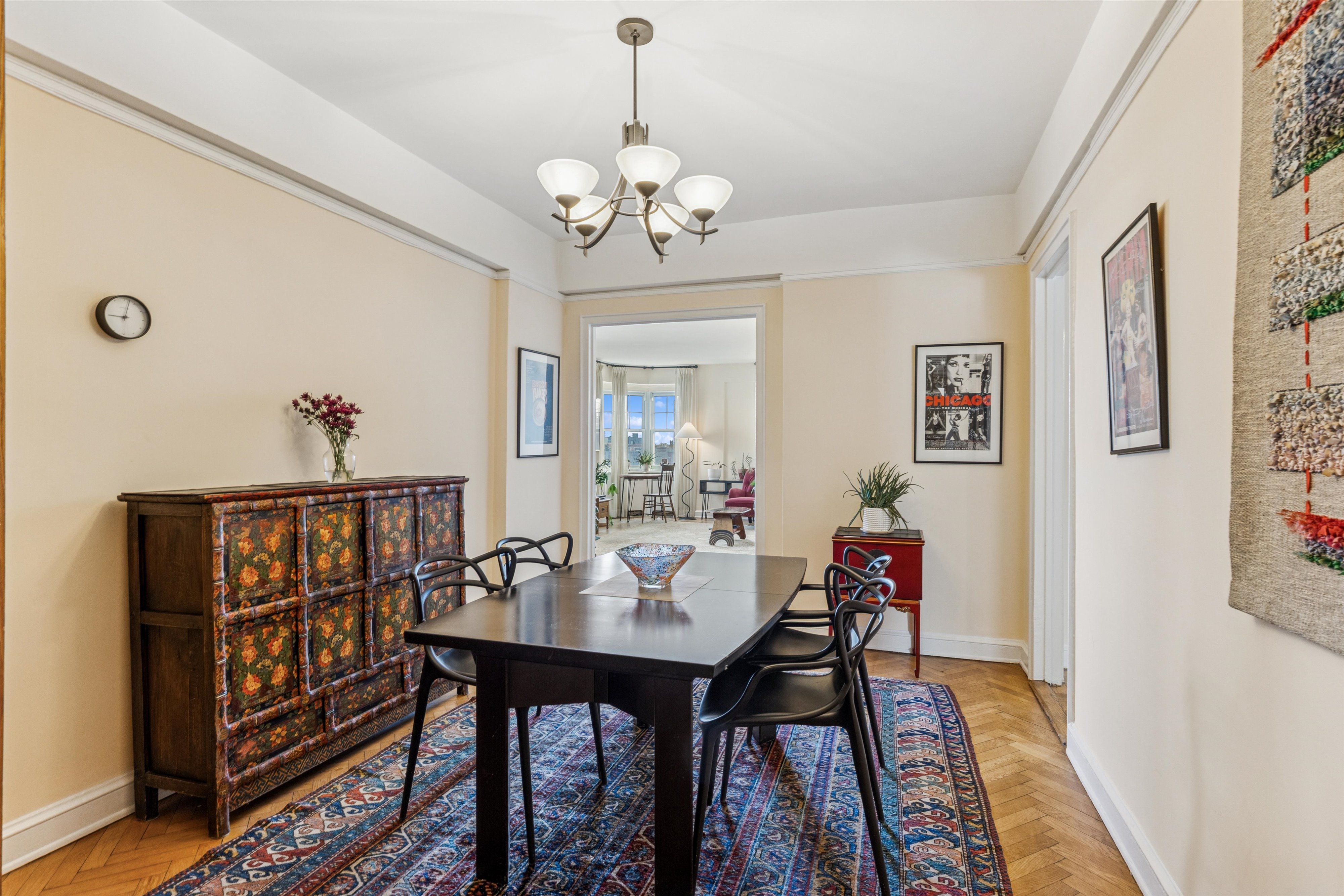 200 Cabrini Boulevard, Unit 86 Manhattan, NY 10033 - Photo 5 of 26 a view of a dining room with furniture wooden floor and a chandelier