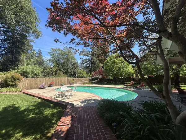 a backyard of a house with table and chairs
