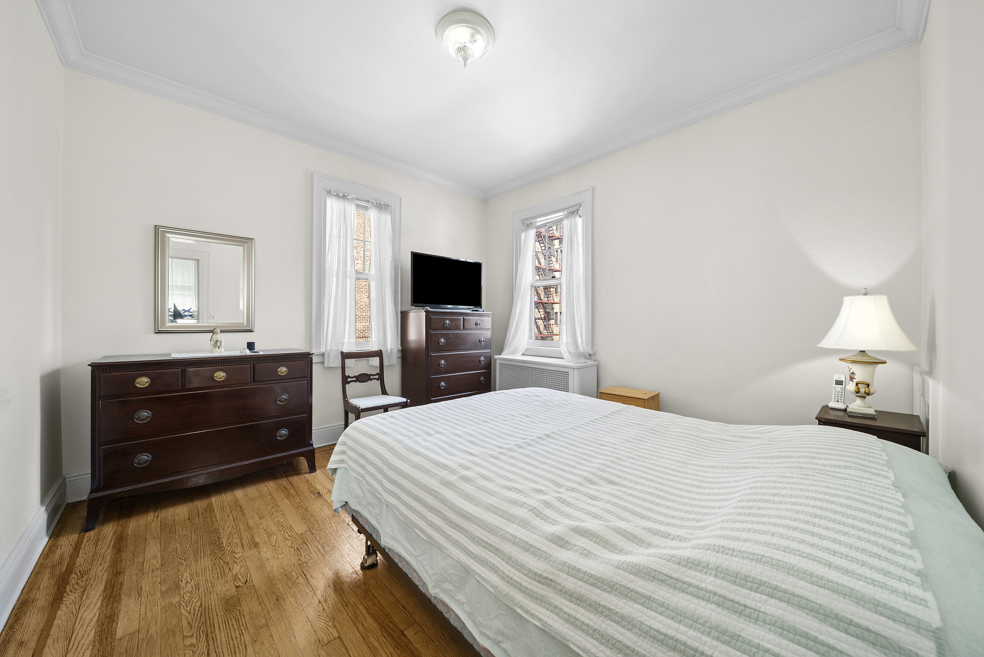 34-15 88th Street Queens, NY 11372 - Photo 10 of 15 a bedroom with a bed and a television