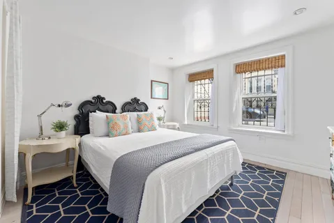 a bedroom with bed and a window