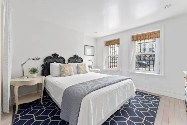 a bedroom with bed and a window