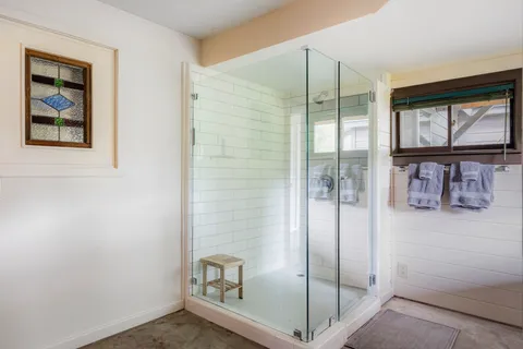 a bathroom with a shower and closet