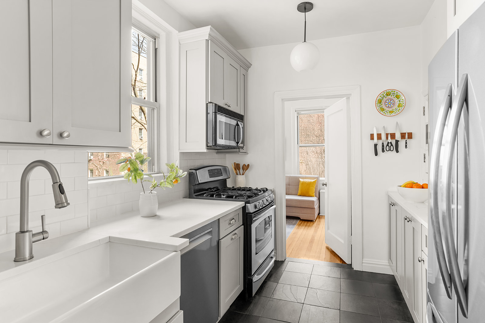 35-47 80th Street, Unit 21 Queens, NY 11372 - Photo 4 of 14 a kitchen with a sink a stove a refrigerator and a window