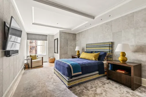 a bedroom with a bed and flat screen tv